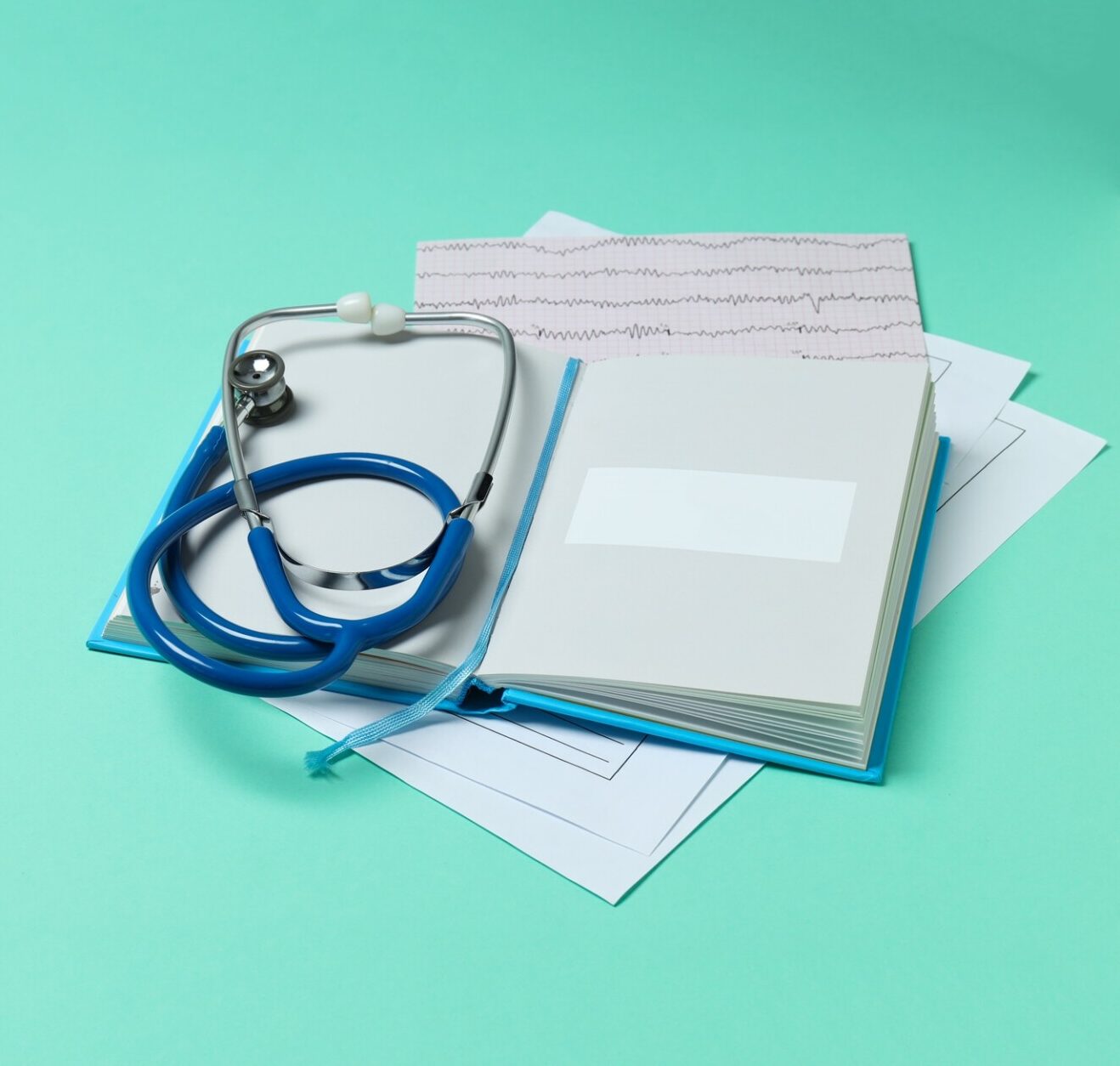 Medical literature - book and medical accessories on mint background